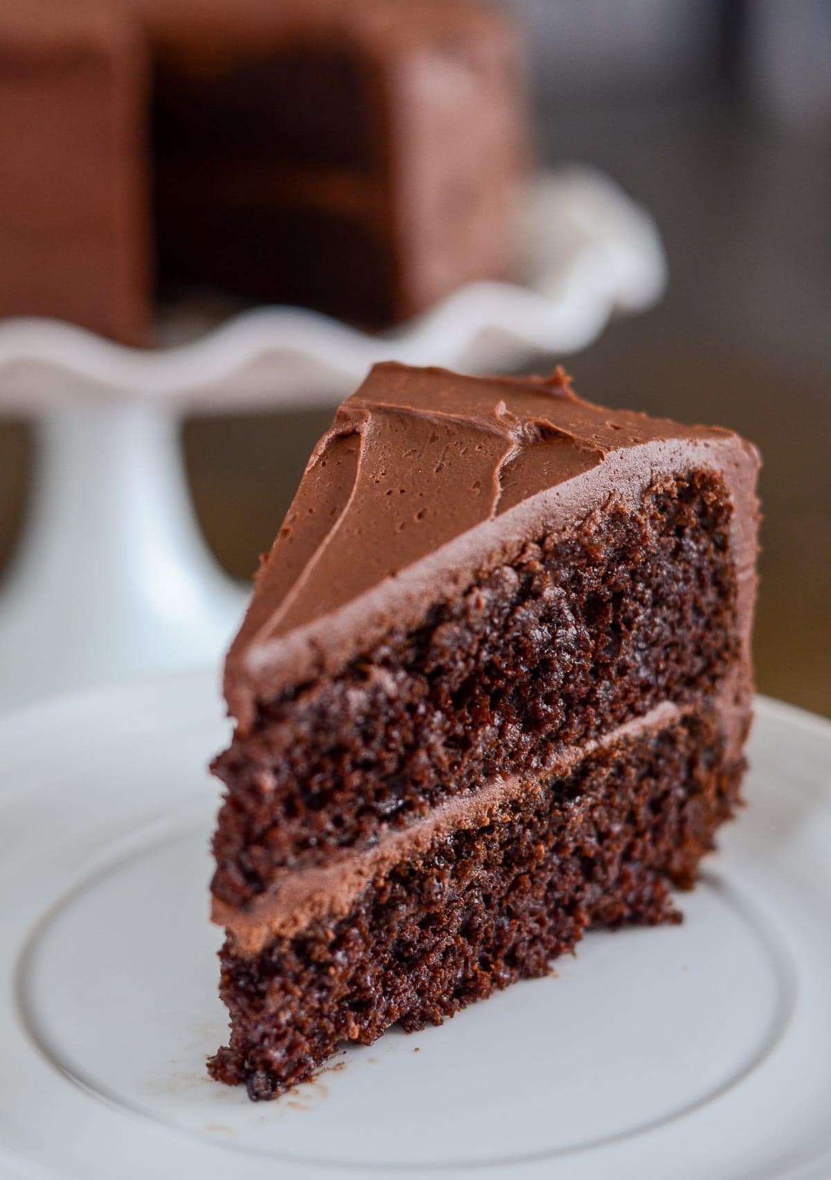 A rich layered chocolate cake with creamy frosting and a decadent dark chocolate finish